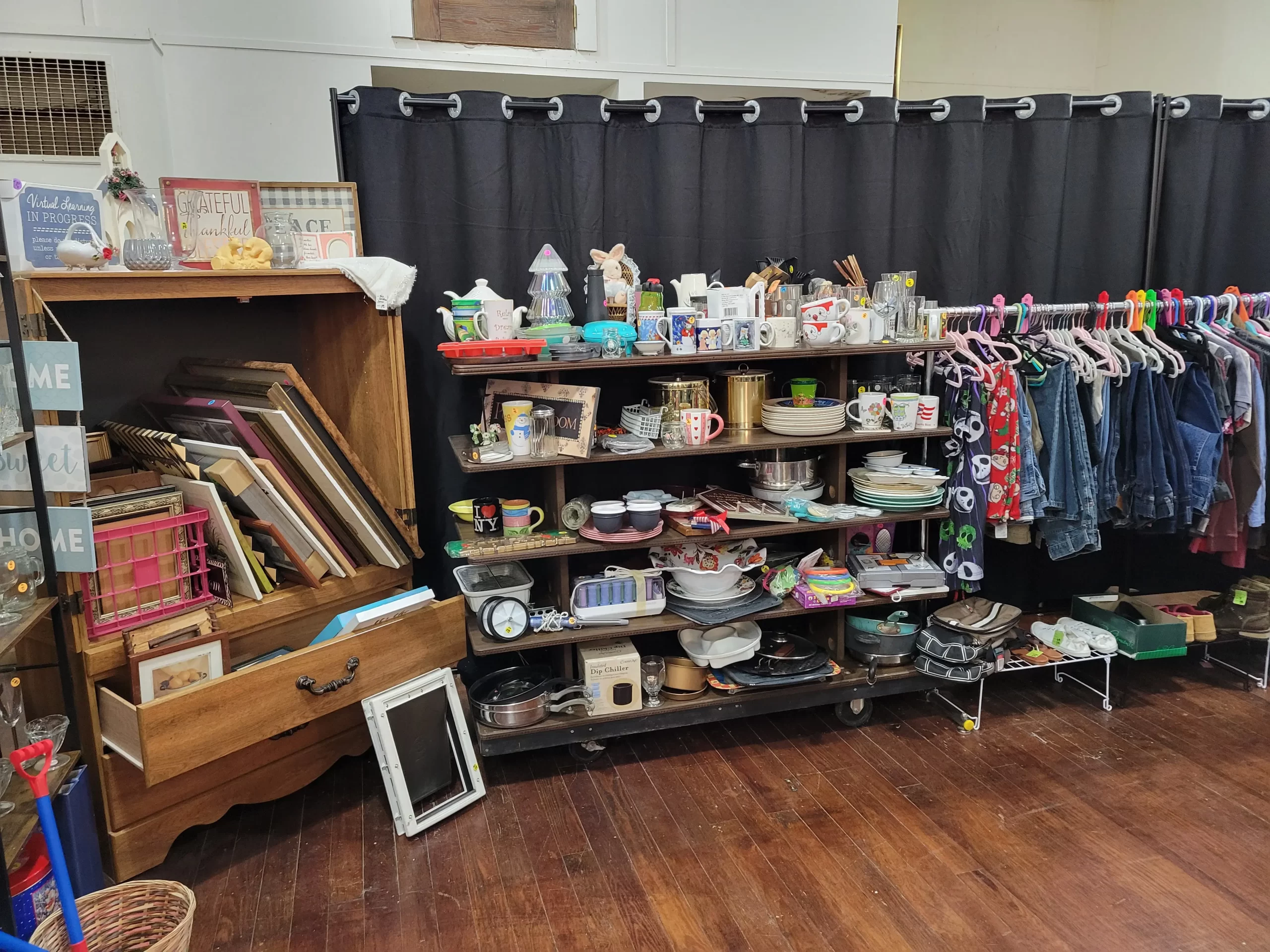 Home goods for sale, such as mugs, cups, picture frames, and decor